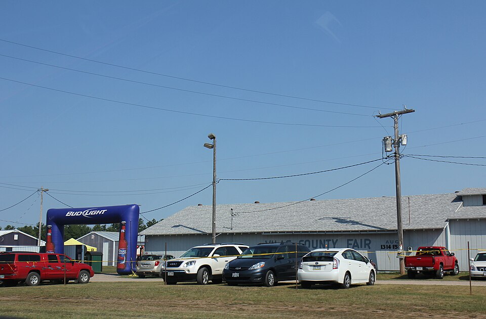 Cars parked by the entrance to the Vilas County Fairgrounds during the 2015 fair, Vilas County, Wisconsin